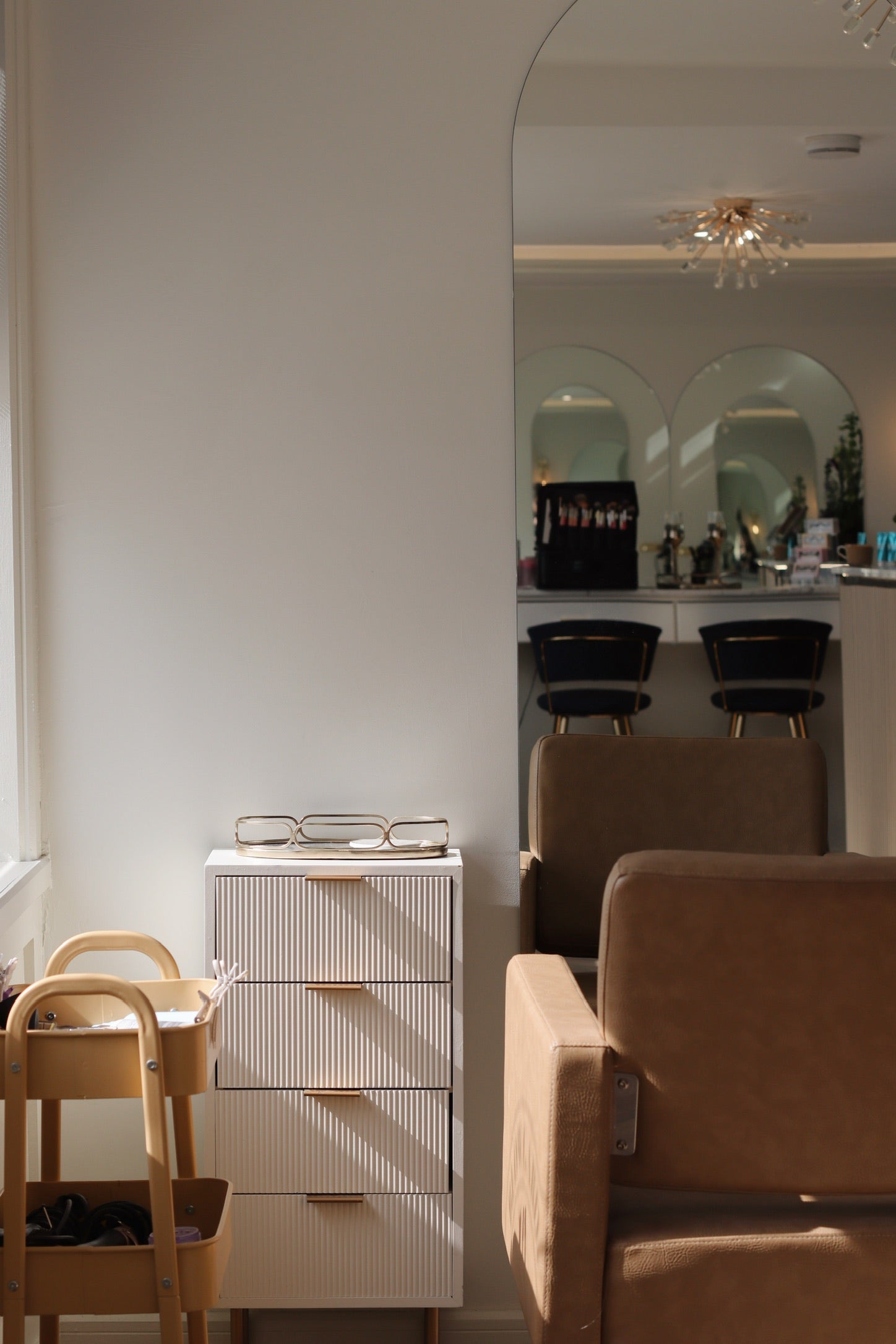 Salon interior with brown chairs, white cabinet, and mirrors on the wall. Blow Garden in West Malling. Beauty marketing and photography in kent.